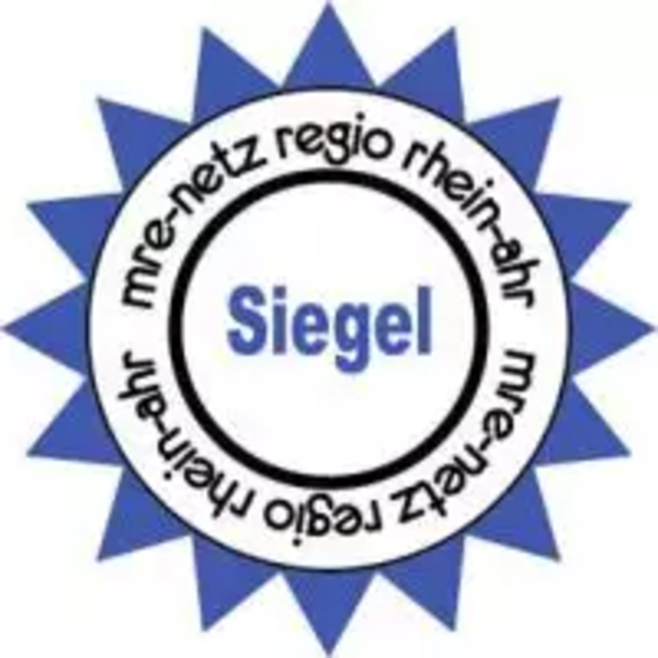 Blaues, sternförmiges Siegel mit dem Text 'Siegel' in der Mitte und dem umlaufenden Schriftzug 'mrenetz regio rheinahr'