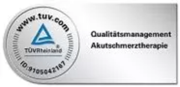 Rundes TÜV-Süd-Siegel mit Text und blauem Dreieck-Logo in der Mitte